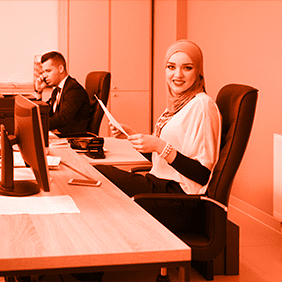 workers at desks reviewing documents in a modern workspace using meeting management system
